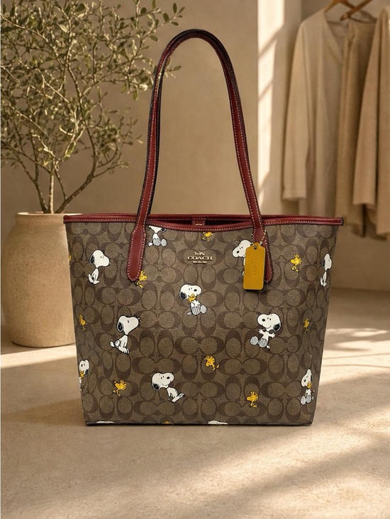 Coach Handbags - Coach Brown Signature Snoopy Tote with Burgundy Trim and Yellow Tag